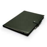Green full-grain leather A4 notebook and pen set, flat lay, angled view — personalised with debossed initials — CarveOn, made in Ireland