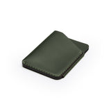 Green full-grain leather quick-draw wallet, flat lay, angled view — personalised — CarveOn, made in Ireland