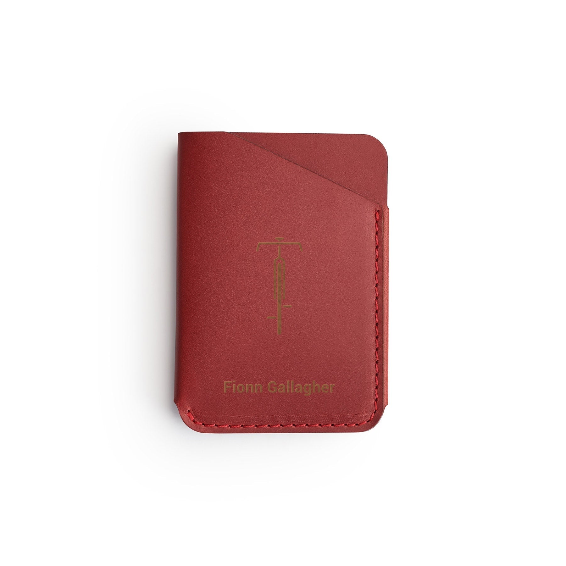 Burgundy full-grain leather quick-draw wallet, flat lay, engraved with a bicycle and a name — personalised — CarveOn, made in Ireland#Color_Burgundy