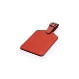 Red full-grain leather luggage tag, flat lay, angled view — personalised travel accessory — CarveOn, made in Ireland