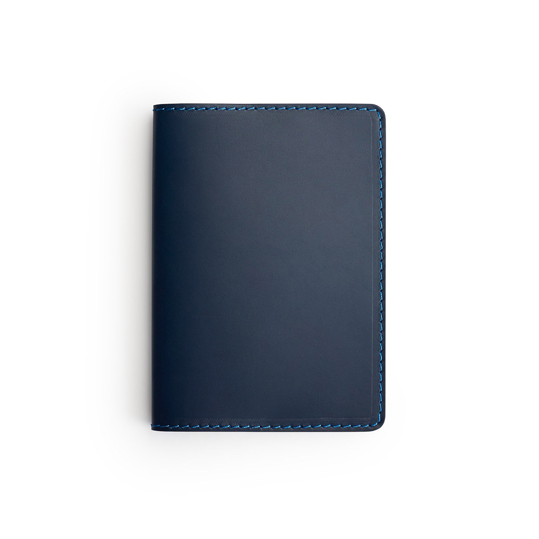 Navy full-grain leather passport holder, flat lay — personalised travel gift — CarveOn, made in Ireland#Color_Navy