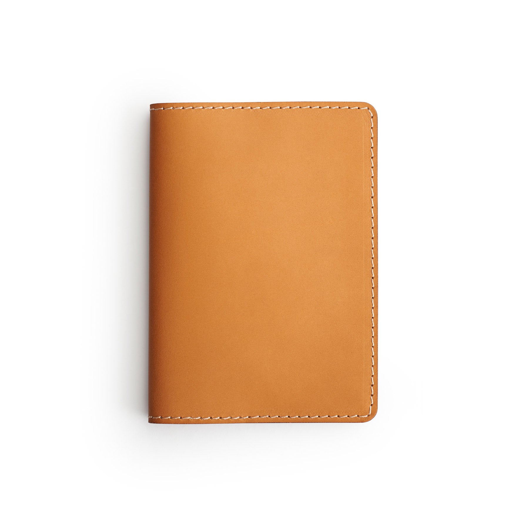 Tan full-grain leather passport holder, flat lay — personalised travel gift — CarveOn, made in Ireland#Color_Tan