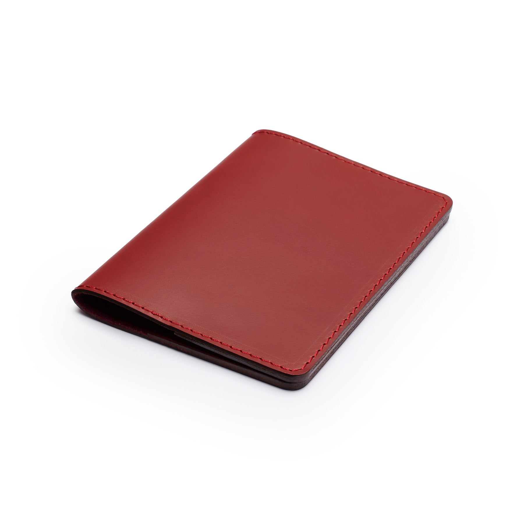 Burgundy full-grain leather passport holder, flat lay, angled view — personalised travel gift — CarveOn, made in Ireland#Color_Burgundy