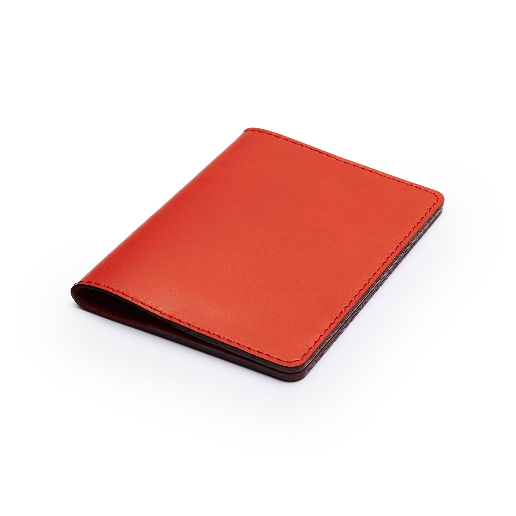 Red full-grain leather passport holder, flat lay, angled view — personalised travel gift — CarveOn, made in Ireland#Color_Red