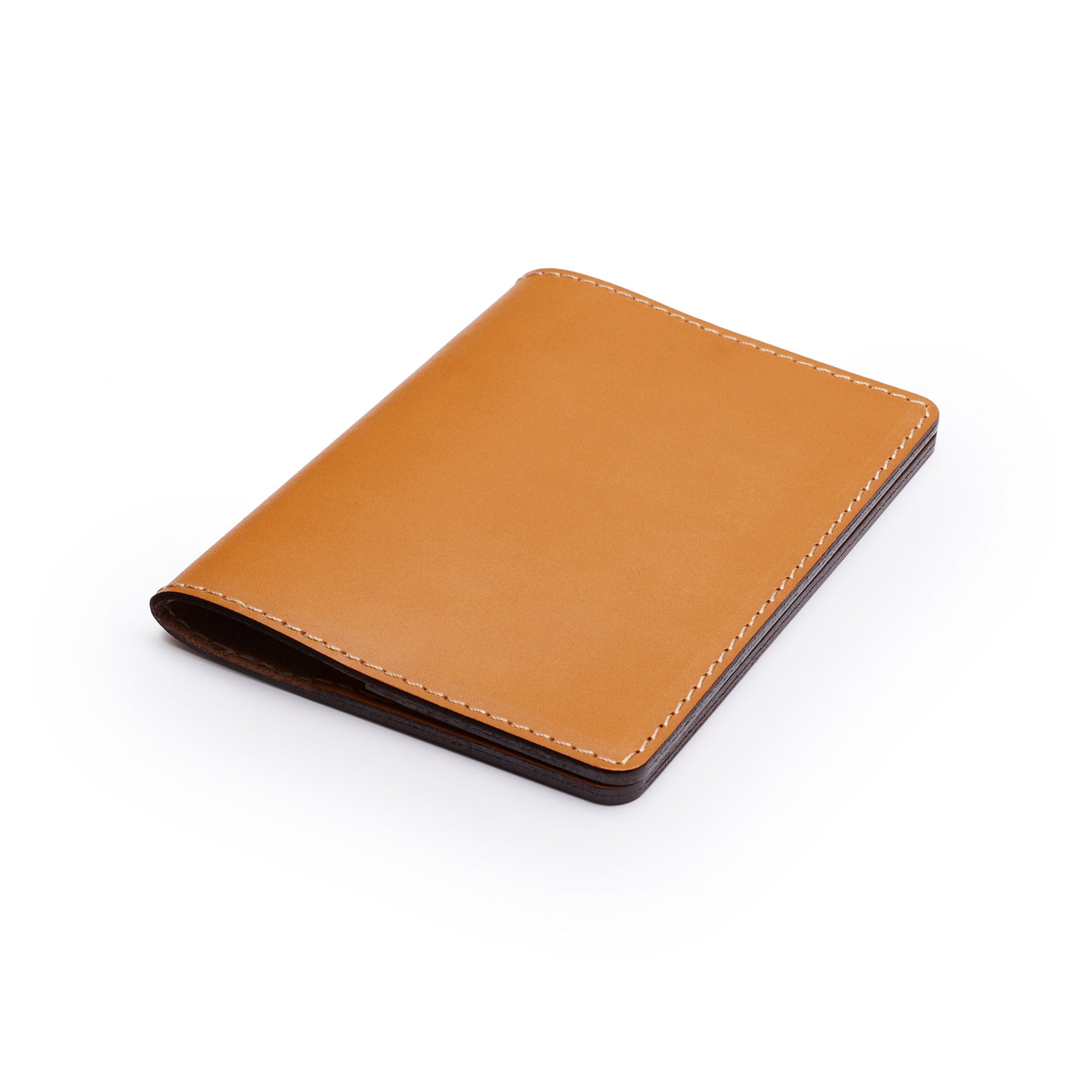 Tan full-grain leather passport holder, flat lay, angled view — personalised travel gift — CarveOn, made in Ireland#Color_Tan