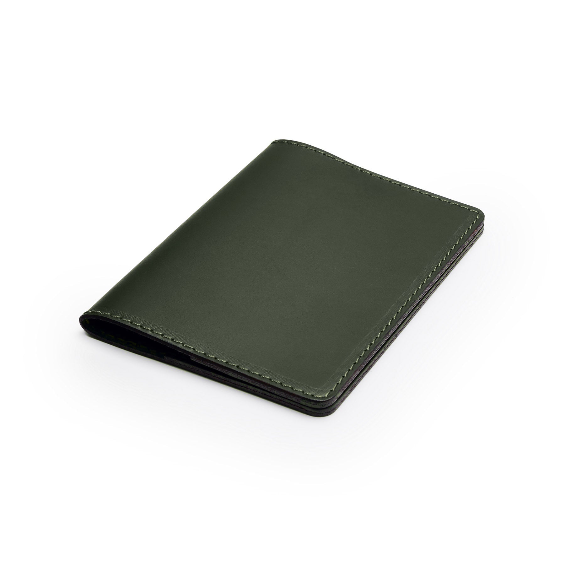 Green full-grain leather passport holder, flat lay, angled view — personalised travel gift — CarveOn, made in Ireland#Color_Green