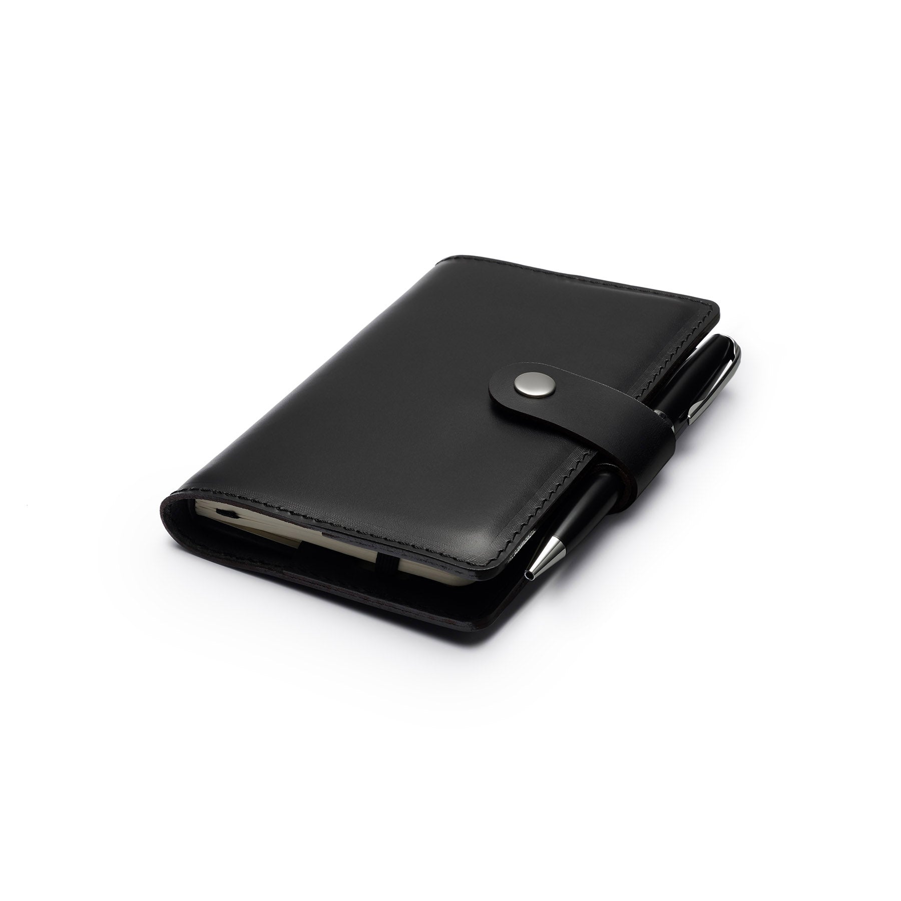 Black full-grain leather A6 notebook and pen set, flat lay, angled view — personalised with debossed initials — CarveOn, m...#Color_Black