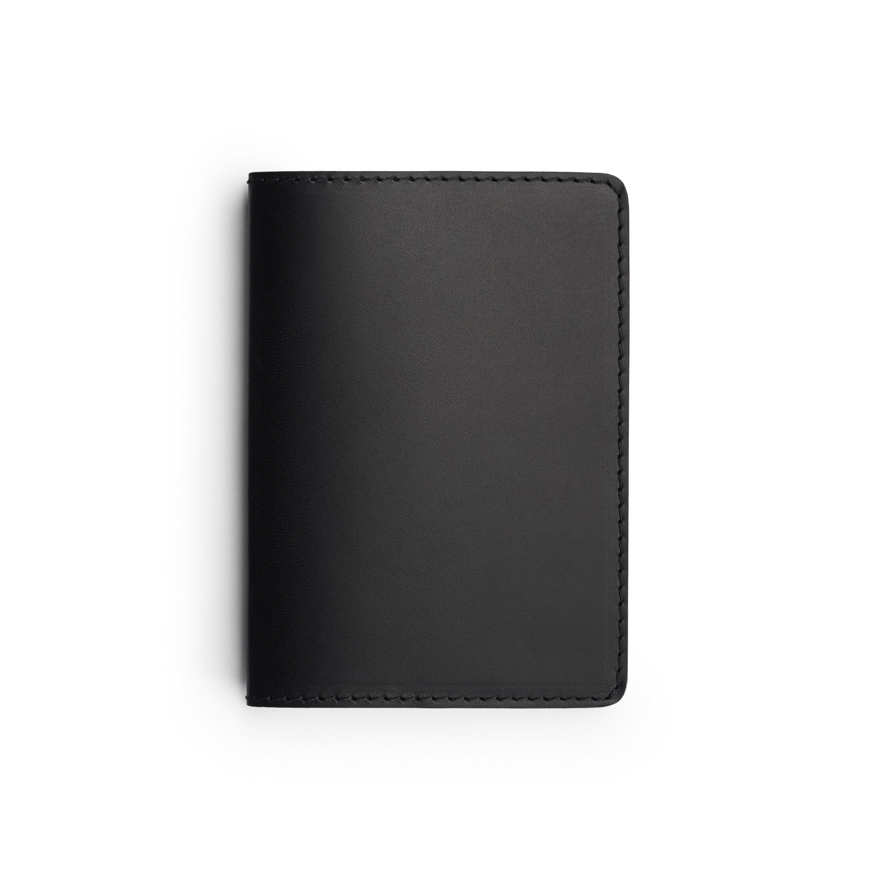 Black full-grain leather passport holder, flat lay — personalised travel gift — CarveOn, made in Ireland#Color_Black