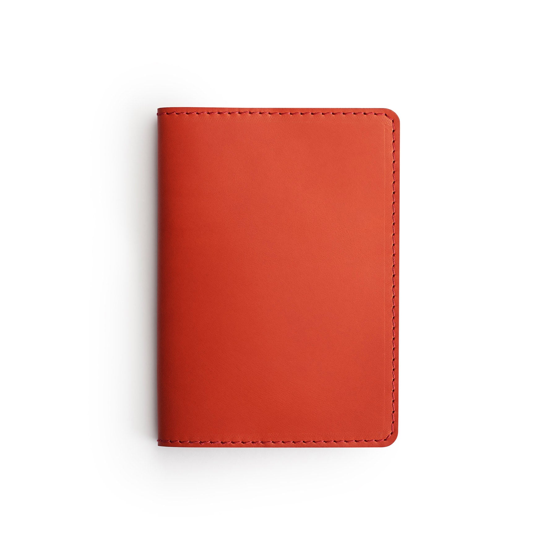 Red full-grain leather passport holder, flat lay — personalised travel gift — CarveOn, made in Ireland#Color_Red