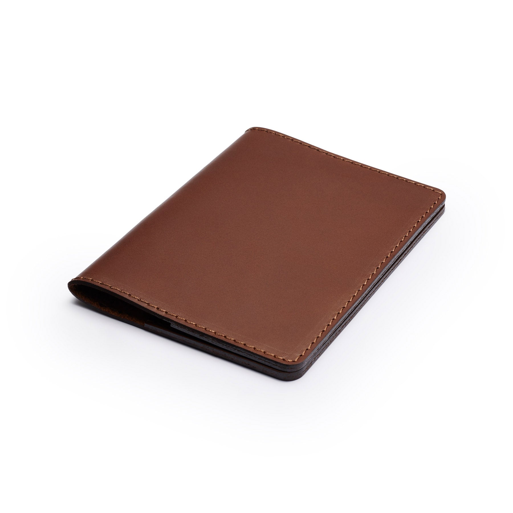 Dark Brown full-grain leather passport holder, flat lay, angled view — personalised travel gift — CarveOn, made in Ireland#Color_Dark Brown