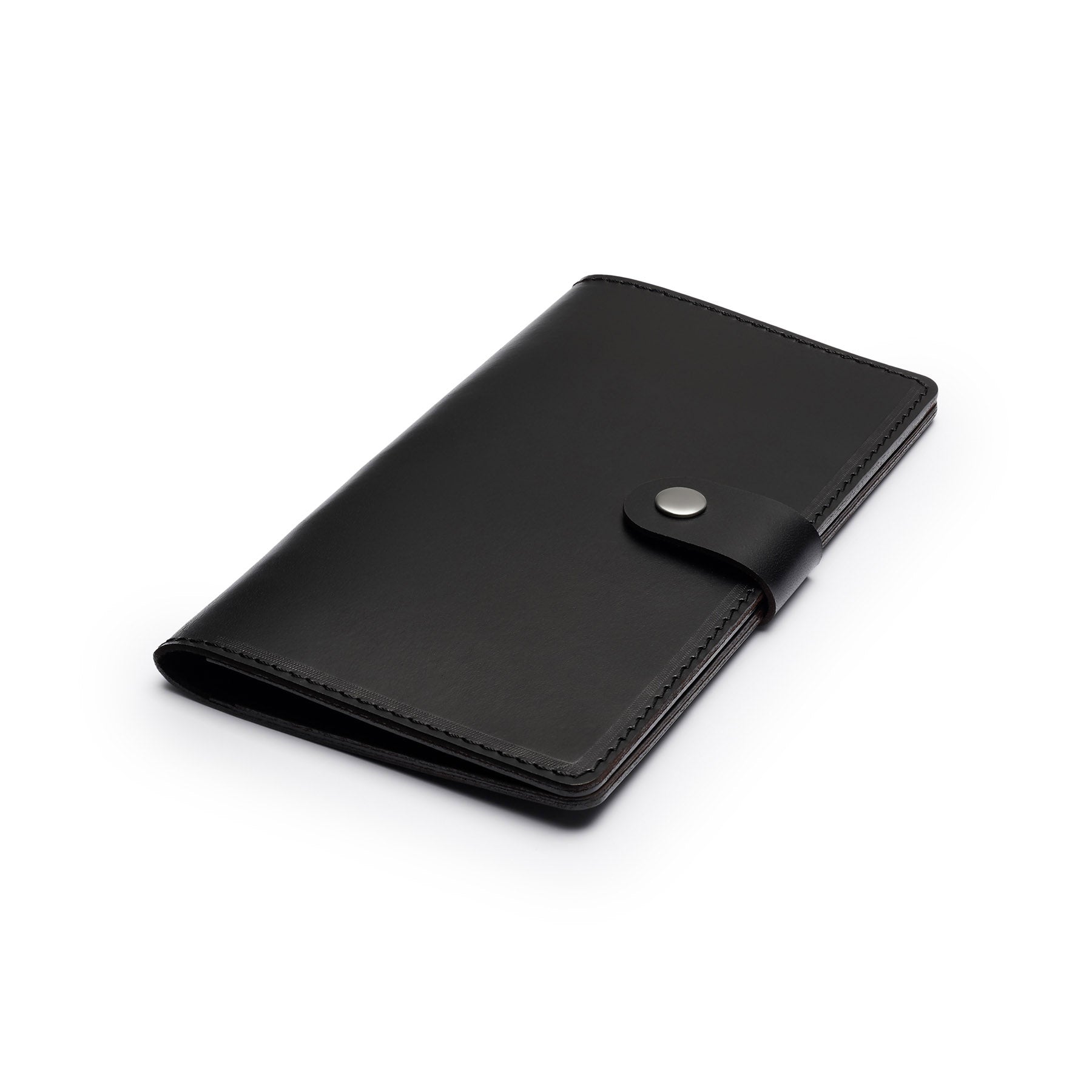 Black full-grain leather travel wallet, flat lay, angled view — personalised — CarveOn, made in Ireland#Color_Black